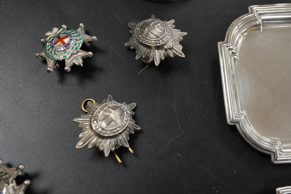 A pair of late Victorian Regimental silver menu holders (Royal Sussex Regiment), a pair of ashtrays and two pairs of uniform pips first height 5cm., weight approx. 7.83ozt